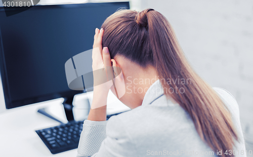 Image of stressed woman with computer