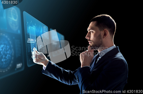 Image of businessman with tablet pc and virtual screens