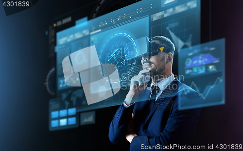 Image of businessman in virtual reality headset and screens