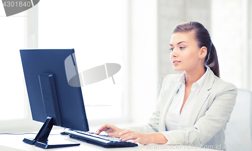 Image of businesswoman with computer in office