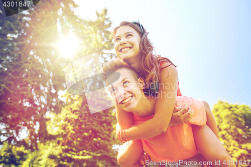 Image of happy teenage couple having fun at summer park