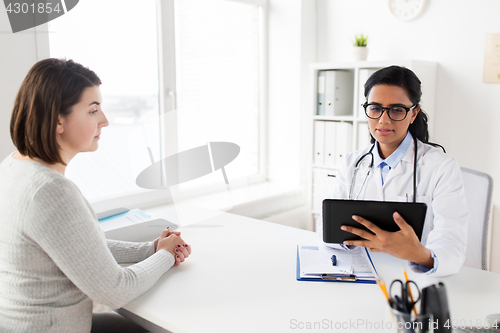 Image of doctor with tablet pc and woman patient at clinic