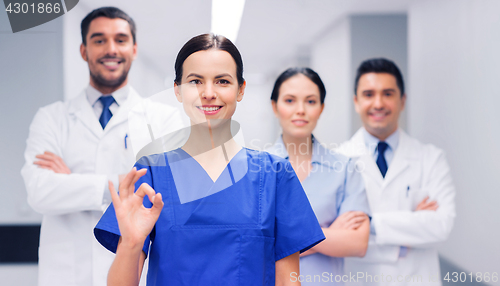 Image of group of medics at hospital showing ok hand sign