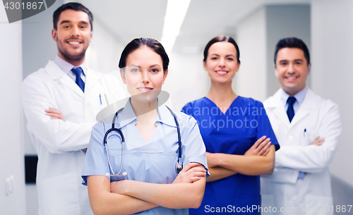 Image of happy group of medics or doctors at hospital