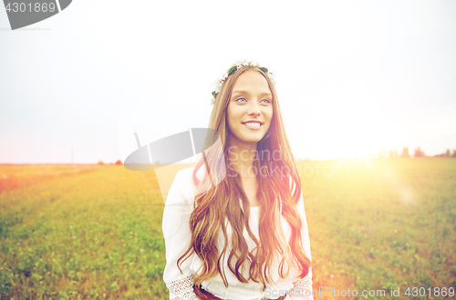 Image of smiling young hippie woman on cereal field