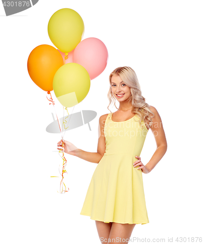 Image of happy woman in dress with helium air balloons