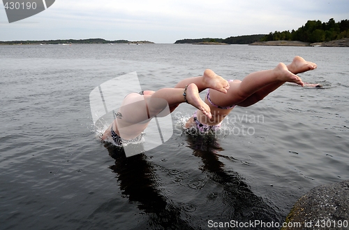 Image of Two girls diving in.