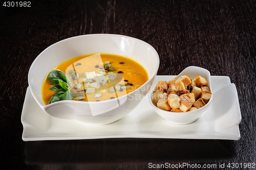 Image of Pumpkin and soup with cream and pumpkin seeds