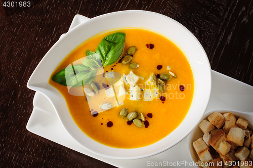 Image of Pumpkin and soup with cream and pumpkin seeds