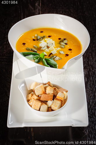 Image of Pumpkin and soup with cream and pumpkin seeds