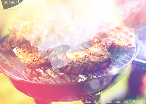 Image of meat cooking on barbecue grill at summer party