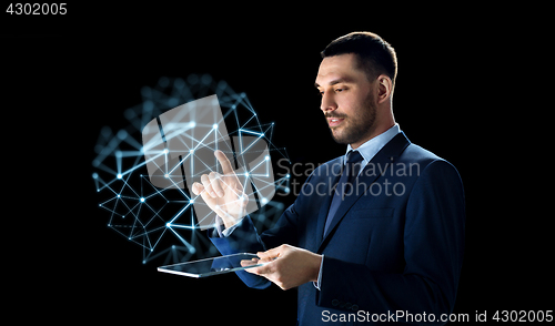 Image of businessman with tablet pc and low poly projection