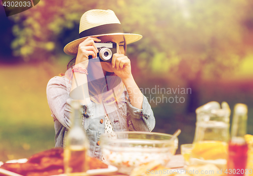 Image of close up of woman with camera shooting outdoors