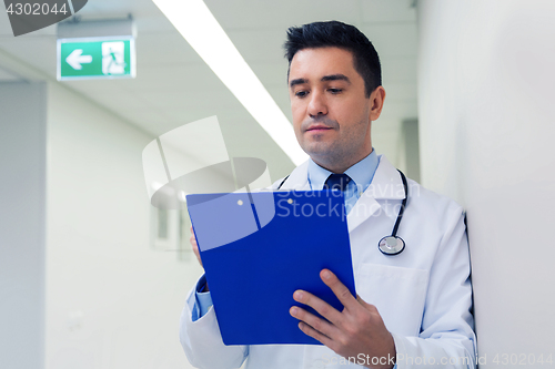 Image of doctor writing to clipboard at hospital