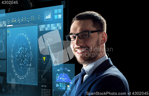 Image of smiling businessman in glasses over black