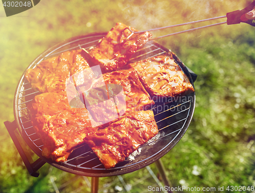 Image of meat cooking on barbecue grill at summer party