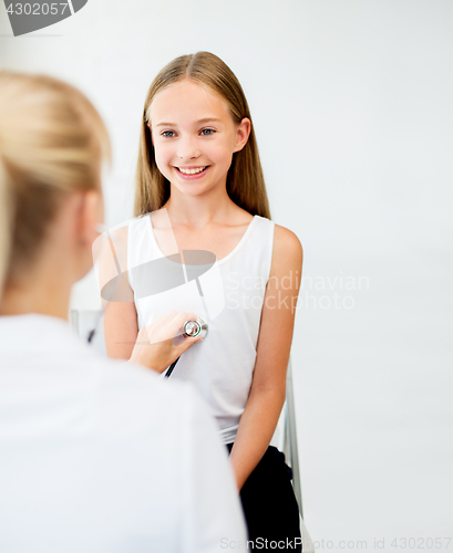 Image of doctor with stethoscope and girl at hospital