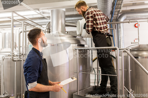 Image of men working at craft brewery or beer plant