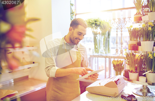 Image of man with tablet pc computer at flower shop