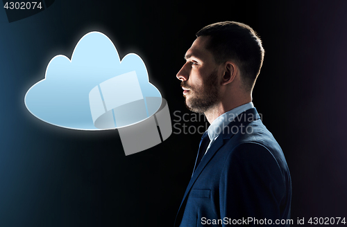 Image of businessman in suit looking at cloud projection