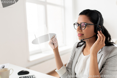 Image of businesswoman with headset talking at office