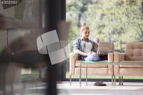 Image of woman drinking coffee enjoying relaxing lifestyle