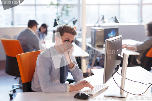 Image of businessman working using a computer in startup office