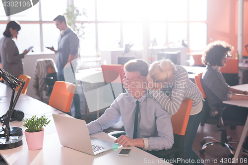 Image of Two Business People Working With laptop in office