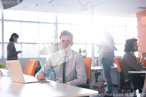 Image of businessman working using a laptop in startup office