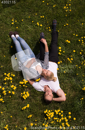 Image of man and woman lying on the grass