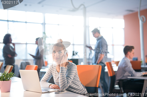 Image of businesswoman using a laptop in startup office