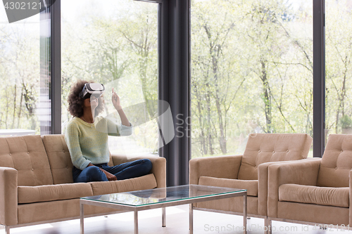 Image of black woman using VR headset glasses of virtual reality