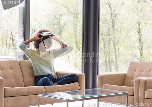 Image of black woman using VR headset glasses of virtual reality