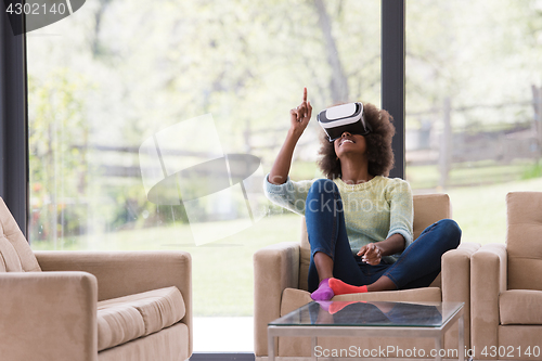 Image of black woman using VR headset glasses of virtual reality