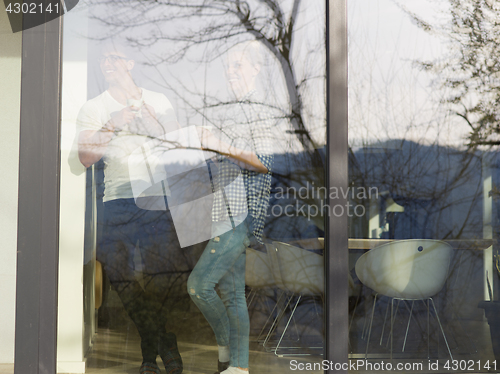 Image of young couple enjoying morning coffee