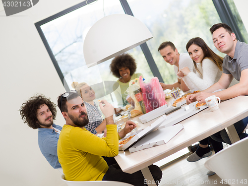 Image of multiethnic group of happy friends lunch time