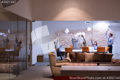 Image of Group of young business people throwing documents