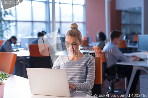 Image of businesswoman using a laptop in startup office