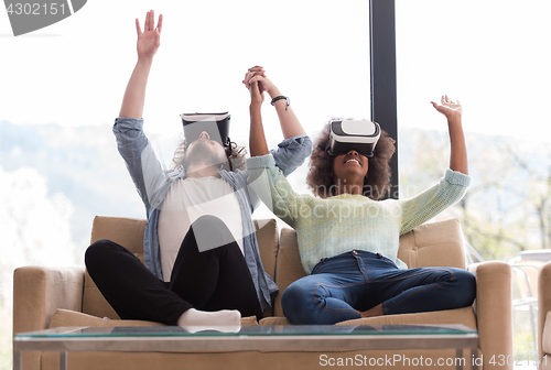 Image of Multiethnic Couple using virtual reality headset