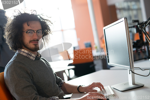 Image of businessman working using a computer in startup office