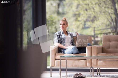 Image of woman drinking coffee enjoying relaxing lifestyle