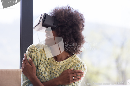 Image of black woman using VR headset glasses of virtual reality