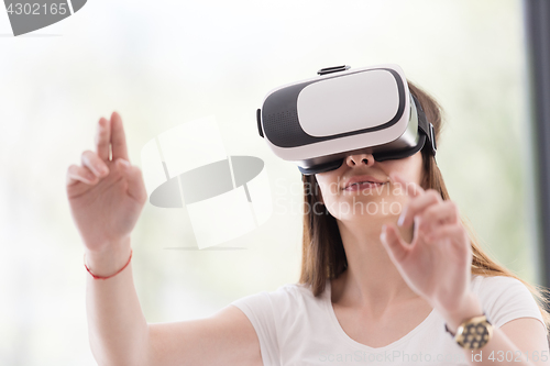 Image of woman using VR-headset glasses of virtual reality