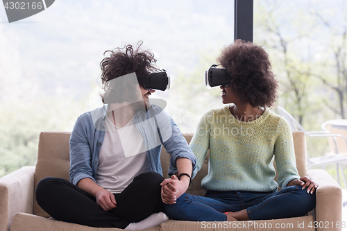 Image of Multiethnic Couple using virtual reality headset