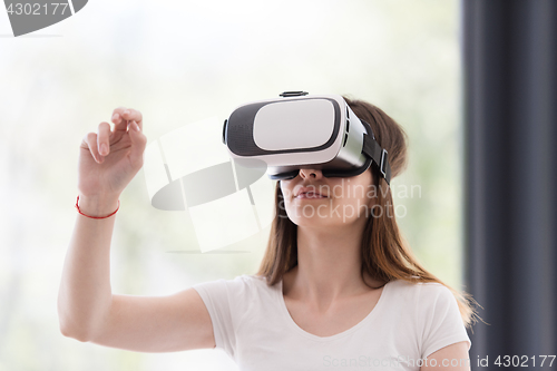 Image of woman using VR-headset glasses of virtual reality