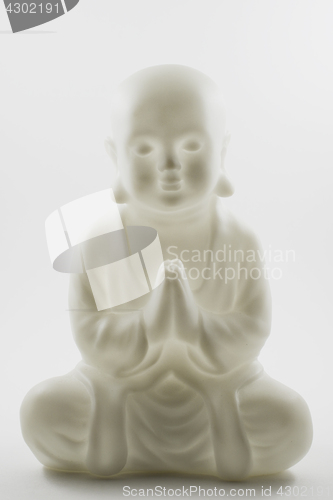 Image of plastic small buddha sculpture on white