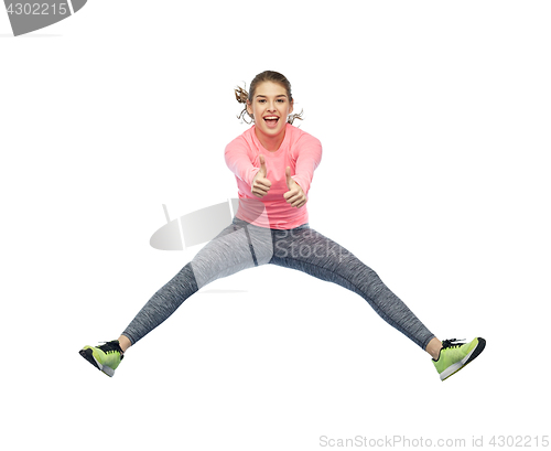 Image of happy smiling sporty young woman jumping in air