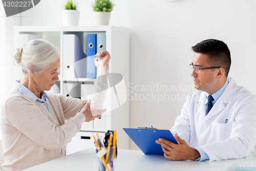 Image of senior woman and doctor meeting at hospital