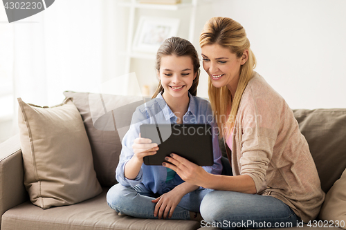 Image of happy family with tablet pc at home