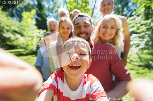 Image of happy family taking selfie in summer garden